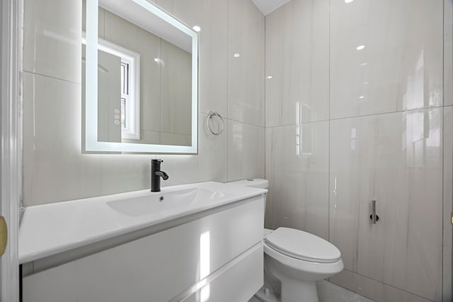 bathroom featuring toilet and vanity