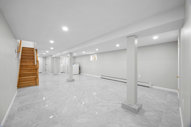 finished basement featuring recessed lighting, baseboards, a baseboard heating unit, and washer / clothes dryer