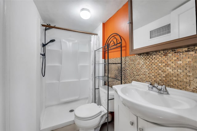 full bathroom featuring a stall shower, toilet, decorative backsplash, and vanity