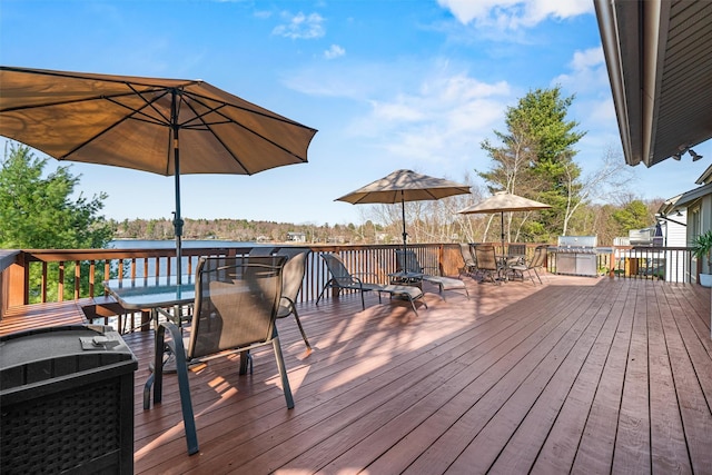 wooden terrace with outdoor dining area