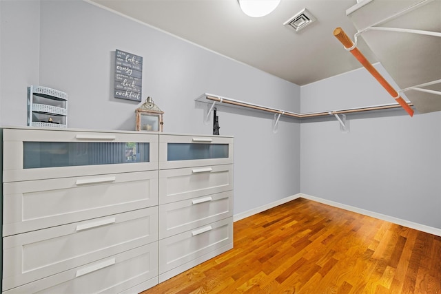 spacious closet with light wood-type flooring and visible vents
