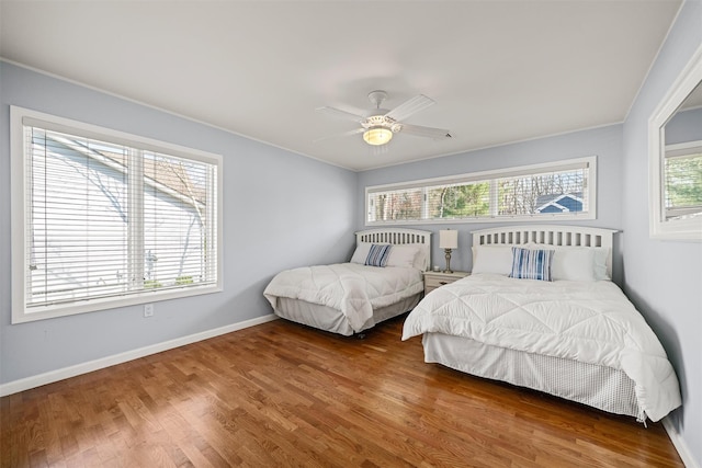 bedroom featuring baseboards, ornamental molding, ceiling fan, and wood finished floors