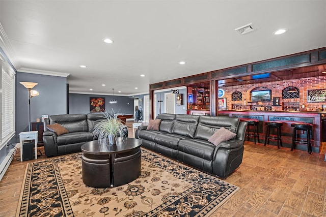 living area featuring recessed lighting, visible vents, ornamental molding, and bar