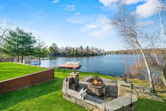 exterior space featuring a water view, a yard, and an outdoor fire pit