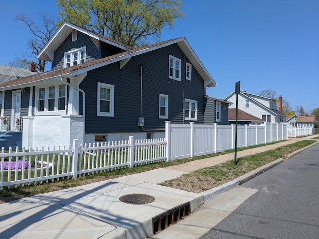 view of home's exterior featuring a residential view and fence private yard