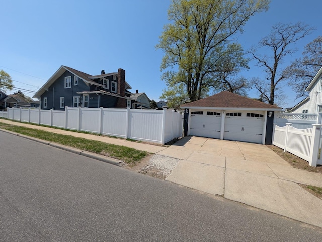 view of side of home with fence, roof with shingles, and a garage