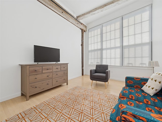 sitting room featuring baseboards and light wood-type flooring