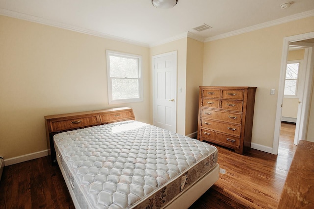 bedroom featuring crown molding, dark wood finished floors, multiple windows, and baseboards