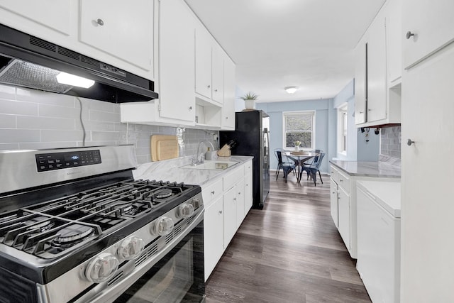 3130 Irwin Ave Unit 2C, Bronx, NY 10463 - kitchen featuring dark wood-style flooring, a sink, decorative backsplash, appliances with stainless steel finishes, and under cabinet range hood
