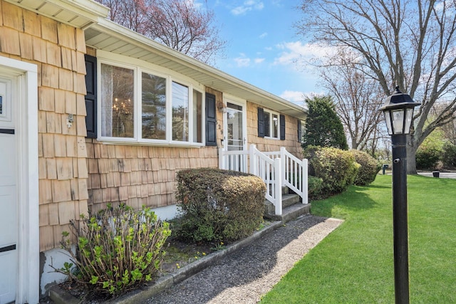 view of exterior entry with a yard