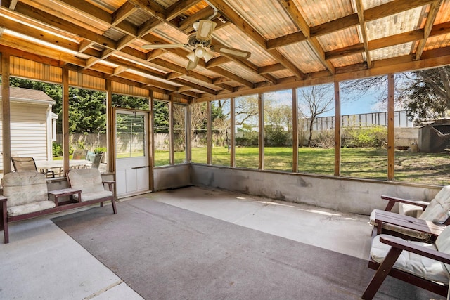 unfurnished sunroom with a ceiling fan