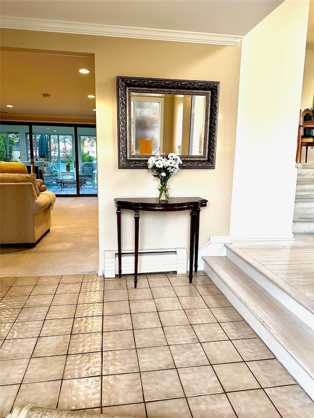 hall featuring tile patterned floors, ornamental molding, baseboard heating, and stairs