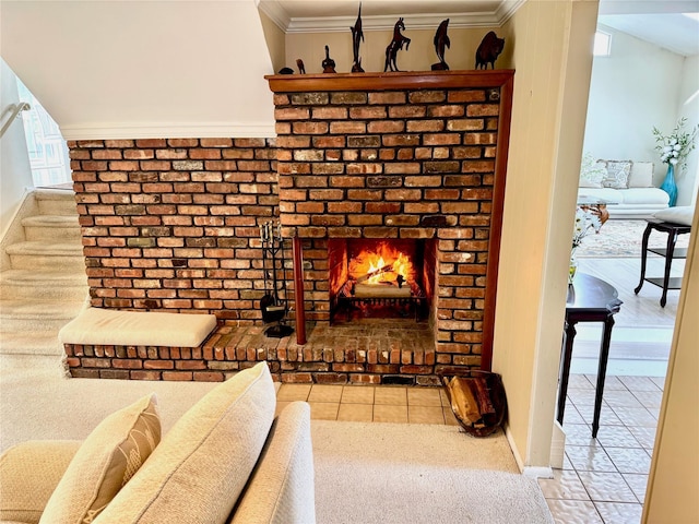 living area with baseboards, ornamental molding, tile patterned flooring, and a brick fireplace