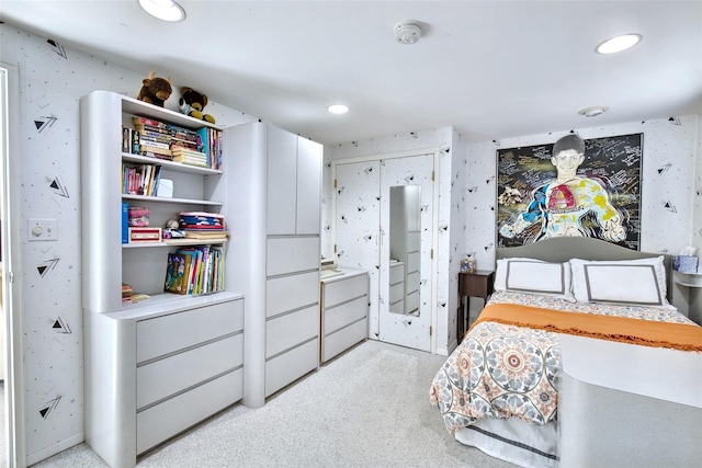 bedroom featuring recessed lighting, wallpapered walls, and light carpet