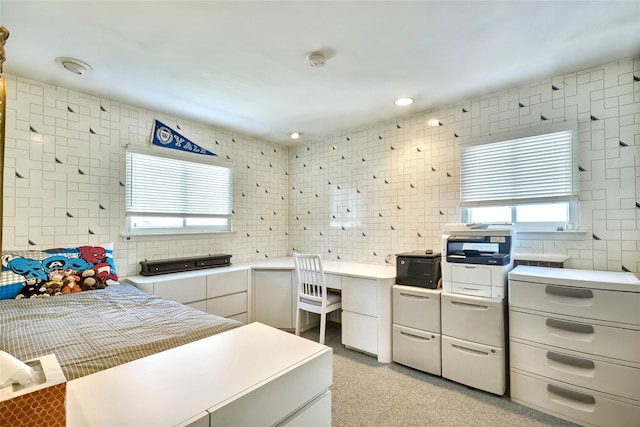 bedroom with tile walls, recessed lighting, and multiple windows