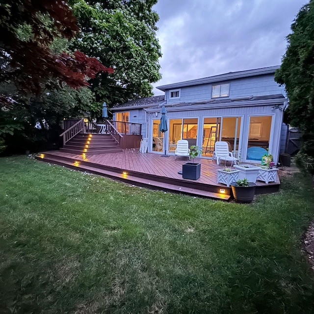 back of house featuring a deck and a yard