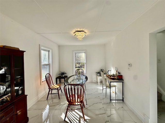 dining room with marble finish floor and baseboards