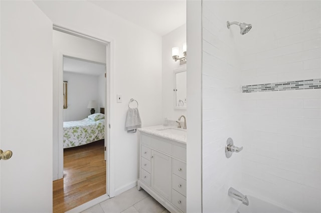full bathroom featuring ensuite bath, tile patterned flooring, shower / bath combination, vanity, and baseboards