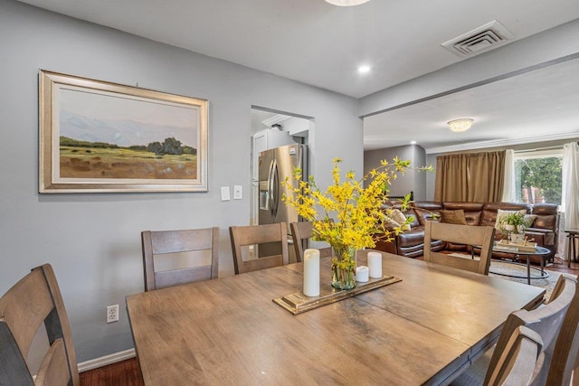 dining space featuring baseboards, visible vents, wood finished floors, and recessed lighting