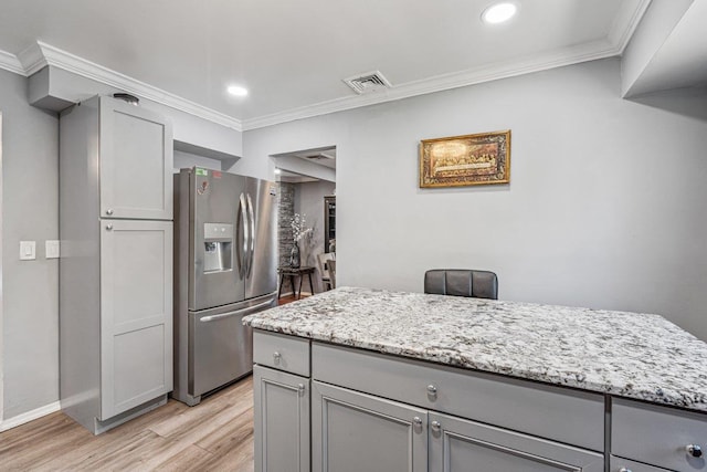 kitchen with visible vents, gray cabinets, stainless steel refrigerator with ice dispenser, and light wood-style floors