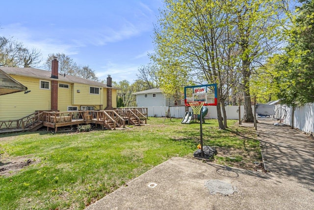 view of yard with stairway, fence, a wooden deck, and a playground
