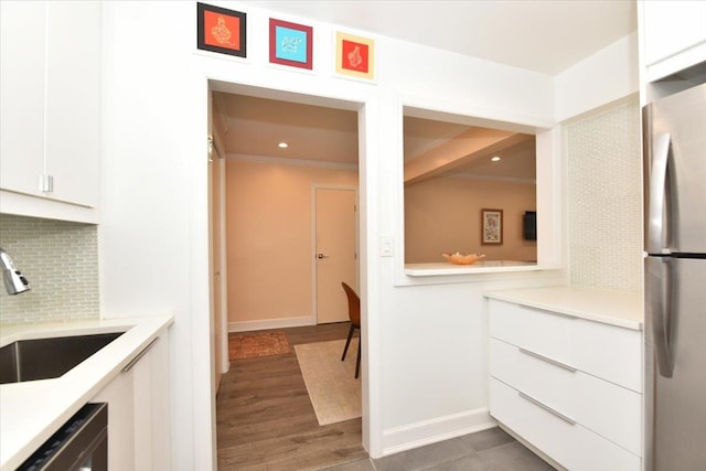 36 Barstow Unit 2-B, Great Neck, NY 11021 - kitchen featuring backsplash, dishwasher, a sink, light countertops, and freestanding refrigerator