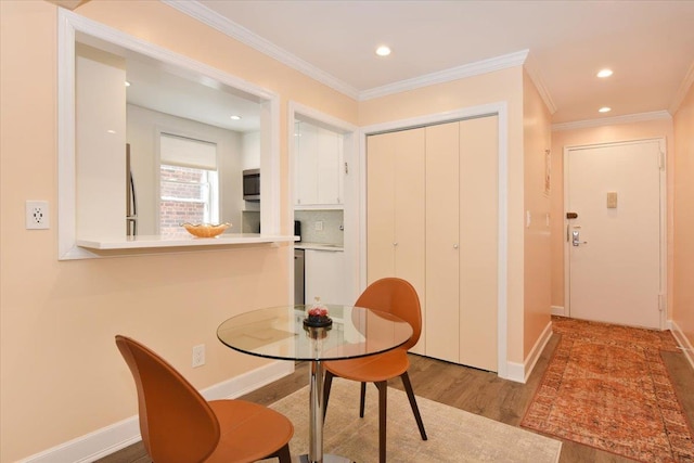 36 Barstow Unit 2-B, Great Neck, NY 11021 - dining room featuring wood finished floors, crown molding, recessed lighting, and baseboards