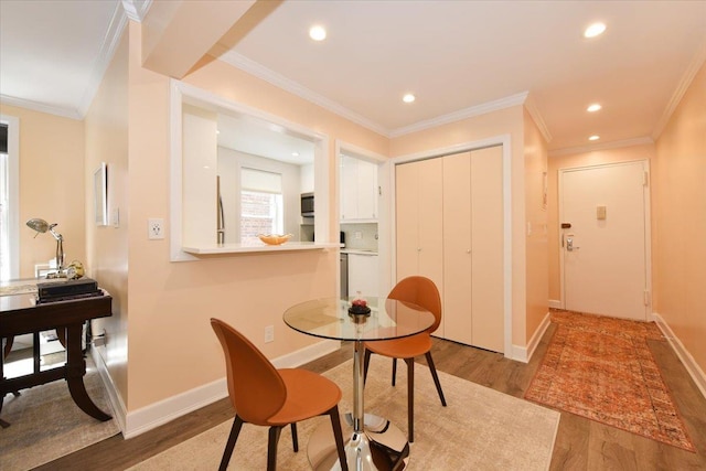36 Barstow Unit 2-B, Great Neck, NY 11021 - dining area with crown molding, light wood-style flooring, recessed lighting, and baseboards