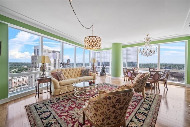 sunroom featuring a chandelier, a view of city, and plenty of natural light
