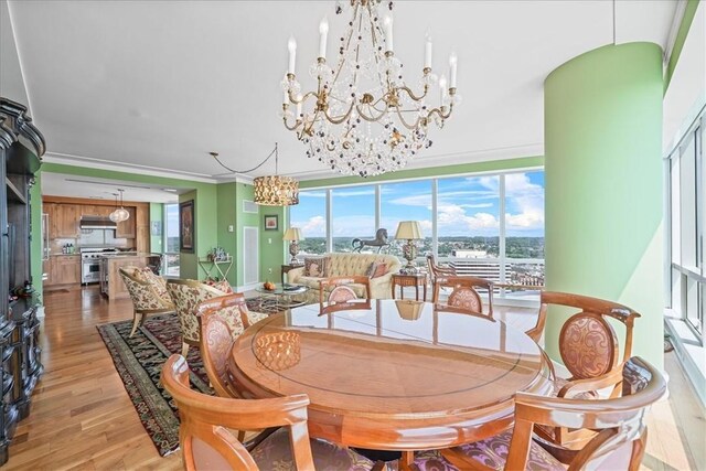 dining area featuring light wood finished floors and a chandelier