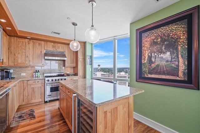 kitchen with under cabinet range hood, light brown cabinets, visible vents, appliances with stainless steel finishes, and beverage cooler
