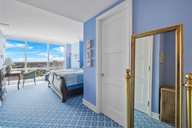 bedroom with floor to ceiling windows, carpet, and baseboards