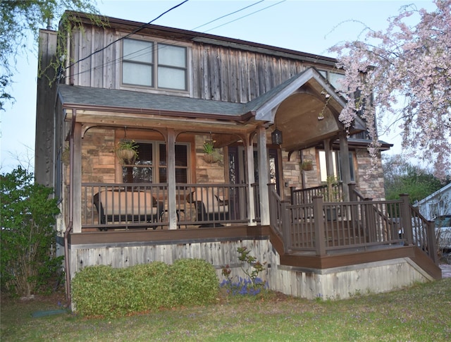 view of front of property with covered porch and stone siding