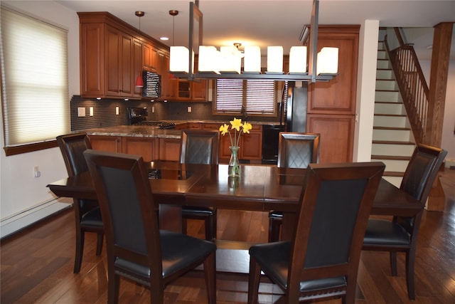 dining room featuring a healthy amount of sunlight, stairs, and dark wood-type flooring