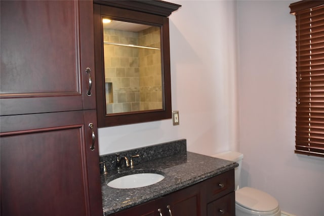 bathroom featuring vanity, baseboards, and toilet