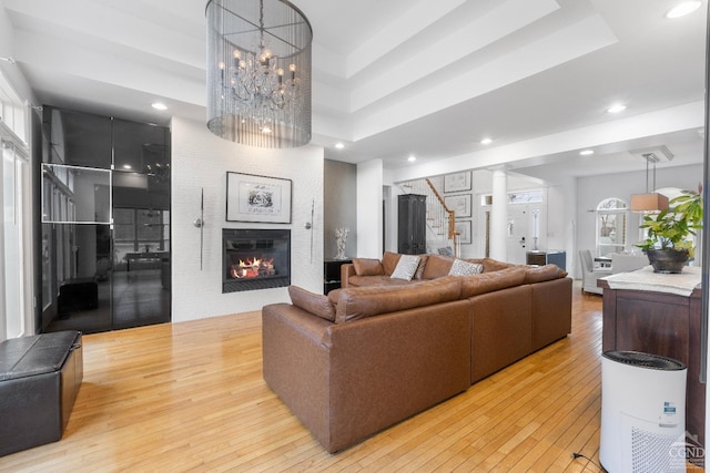 67 Latham Cir, Saugerties, NY 12477 - living room with a fireplace, a wealth of natural light, light wood-style floors, and stairs