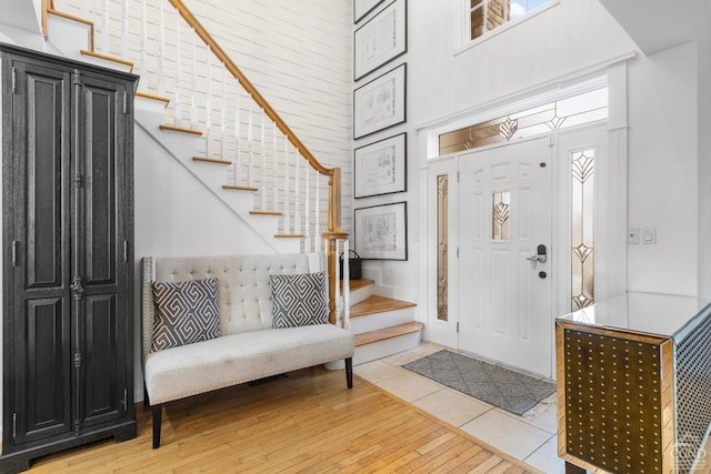 67 Latham Cir, Saugerties, NY 12477 - entrance foyer with stairs, wood-type flooring, and a towering ceiling