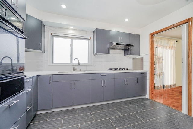 366 Neal Dow Ave, Staten Island, NY 10314 - kitchen featuring gray cabinetry, a sink, under cabinet range hood, backsplash, and recessed lighting