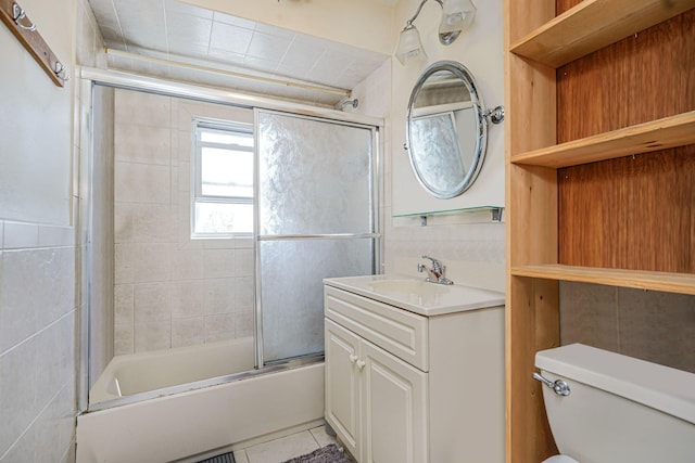 366 Neal Dow Ave, Staten Island, NY 10314 - full bath with tile patterned flooring, enclosed tub / shower combo, toilet, vanity, and tile walls