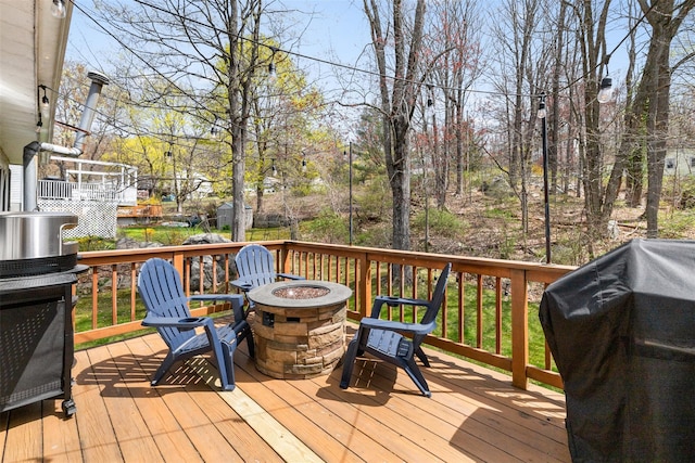 deck featuring a fire pit and grilling area