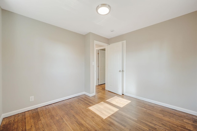 empty room with wood finished floors and baseboards