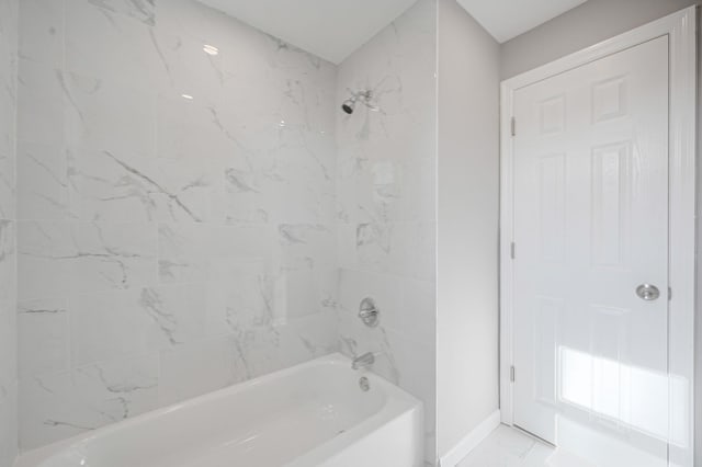 bathroom with marble finish floor, baseboards, and  shower combination