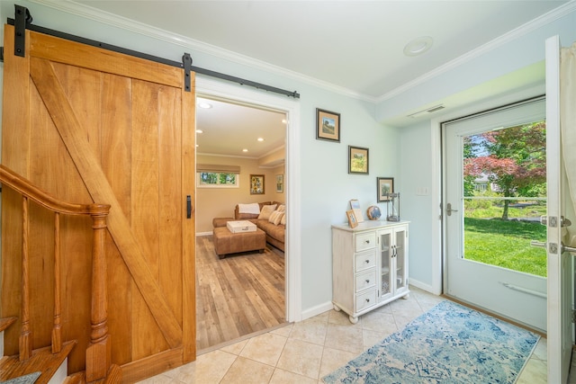 tiled foyer featuring a barn door, ornamental molding, plenty of natural light, baseboards, and recessed lighting
