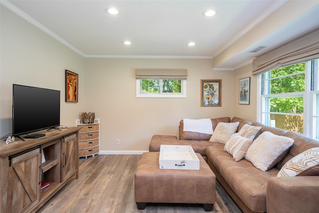 living area with plenty of natural light, light wood-style floors, recessed lighting, crown molding, and baseboards
