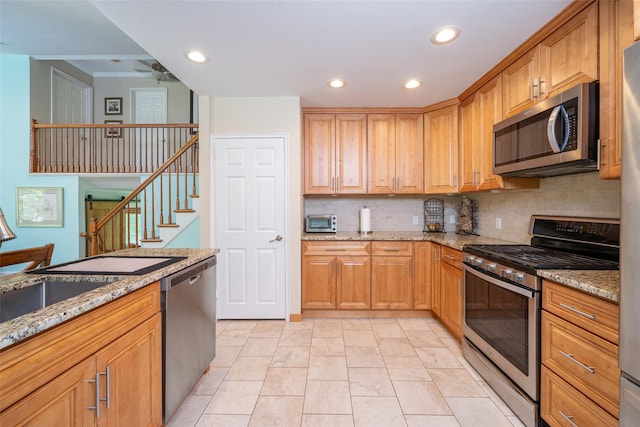 kitchen featuring appliances with stainless steel finishes, light stone countertops, decorative backsplash, recessed lighting, and ceiling fan