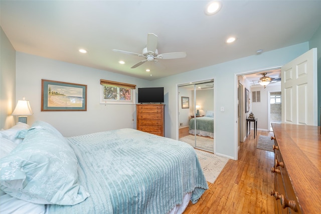 bedroom featuring a closet, recessed lighting, light wood-style flooring, a ceiling fan, and baseboards