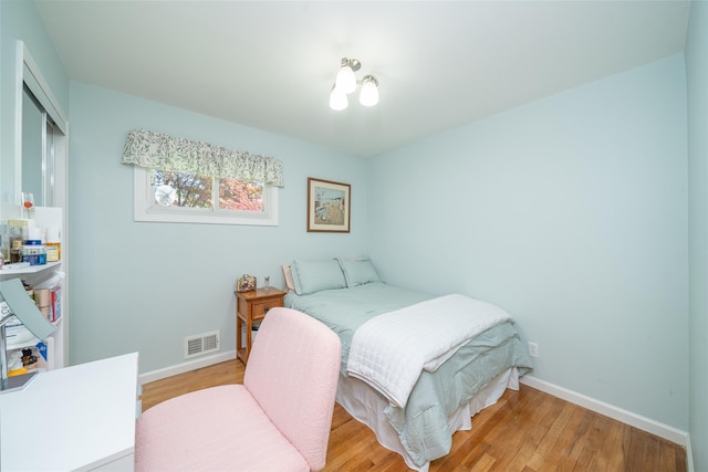 bedroom with baseboards and light wood-type flooring