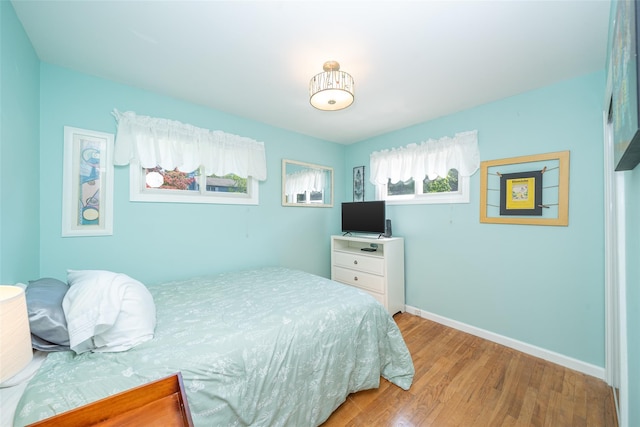 bedroom with wood finished floors and baseboards