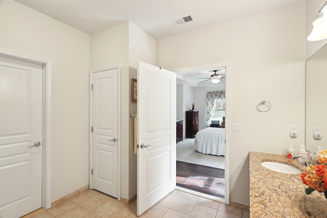 bathroom with connected bathroom, tile patterned flooring, ceiling fan, vanity, and visible vents