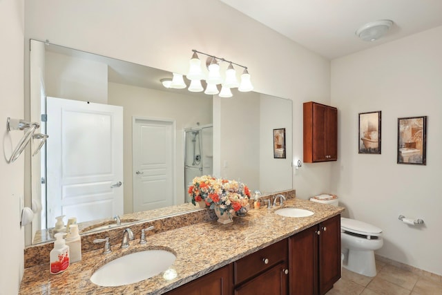 bathroom featuring tile patterned floors, a stall shower, double vanity, and a sink
